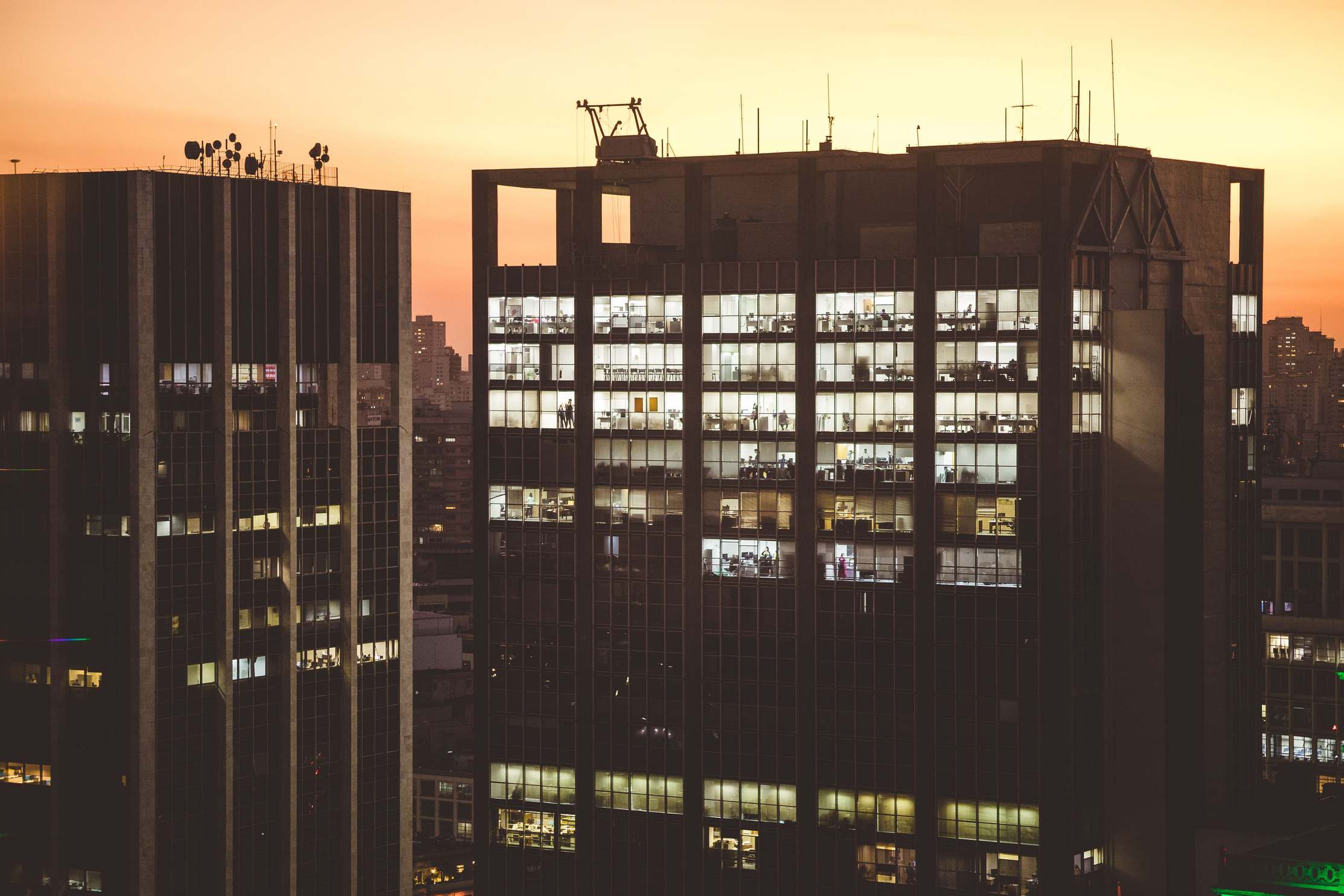 Commercial street with office buildings at dusk, urban cityscape